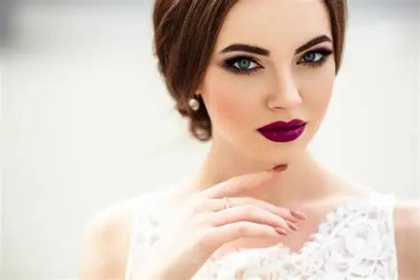 Bride with elegant makeup wearing bold purple lipstick showcasing the best wedding lipsticks for brides