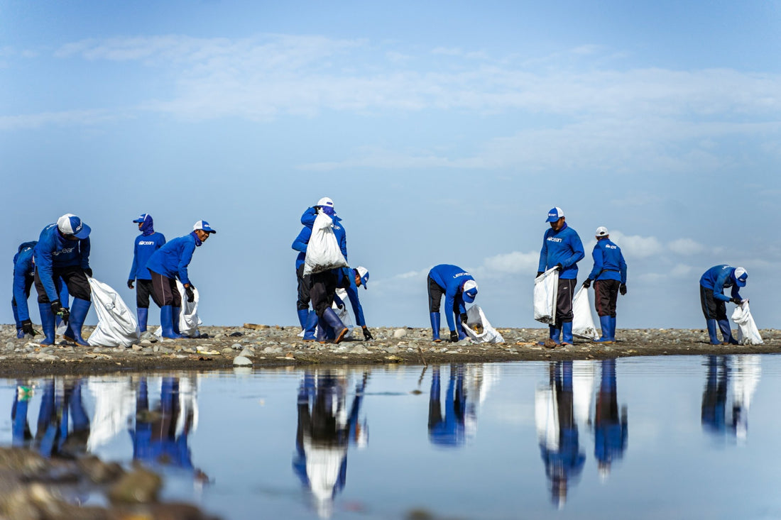 Volunteers cleaning a shoreline to support eco-friendly lip products and environmental sustainability