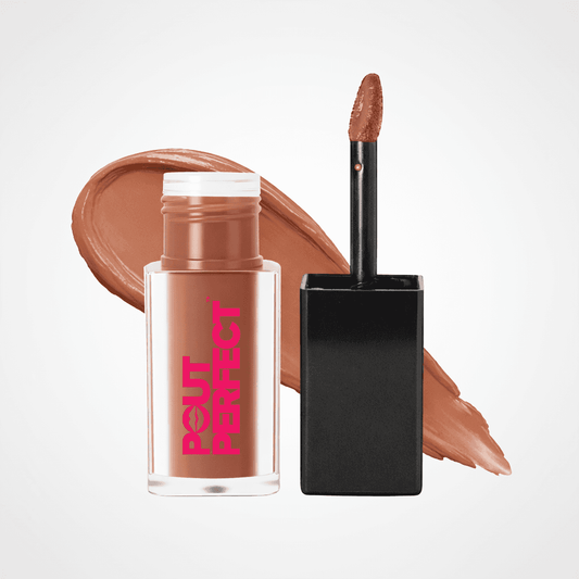 A bottle of Pout Perfect liquid makeup with a black applicator wand shown next to a large smear of the warm nude-brown formula on a light gray . background. Cocoa Kiss