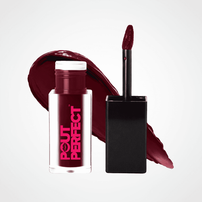 A bottle of Pout Perfect liquid lipstick in a deep berry red shade, shown next to its applicator wand and a matching lipstick smear on a light gray background. Outlandish
