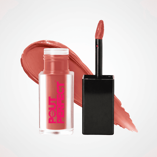 A bottle of Rouget Perfect liquid lipstick in a sheer pink-tinted clear bottle with bright pink branding, shown next to its black cap and applicator wand, with a matching peachy pink product smear behind them on a light gray background. Pink Peach