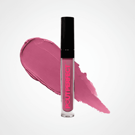 A clear tube of POUT PERFECT liquid lipstick with a black cap, standing in front of a pink makeup smear on a light gray background. Berry Berry