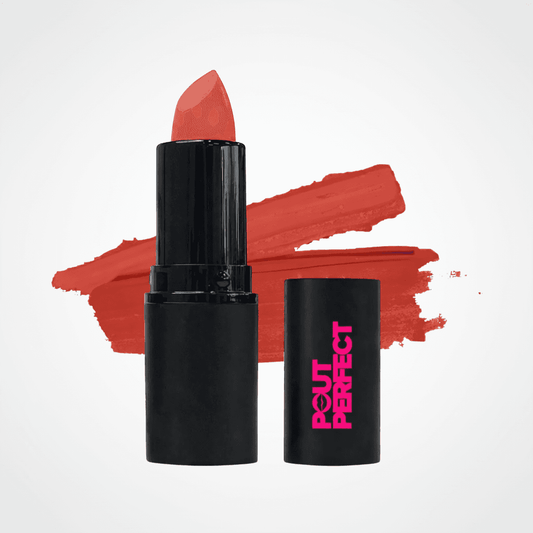 A black lipstick tube with a coral-red lipstick bullet standing upright, alongside its matching black cap printed with pink 'OUT PERFECT' text, set against a white background with a coral-red lipstick swatch behind it.