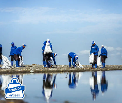 Ecodrive team collecting trash on shore as part of ocean plastic removal services cleanup effort