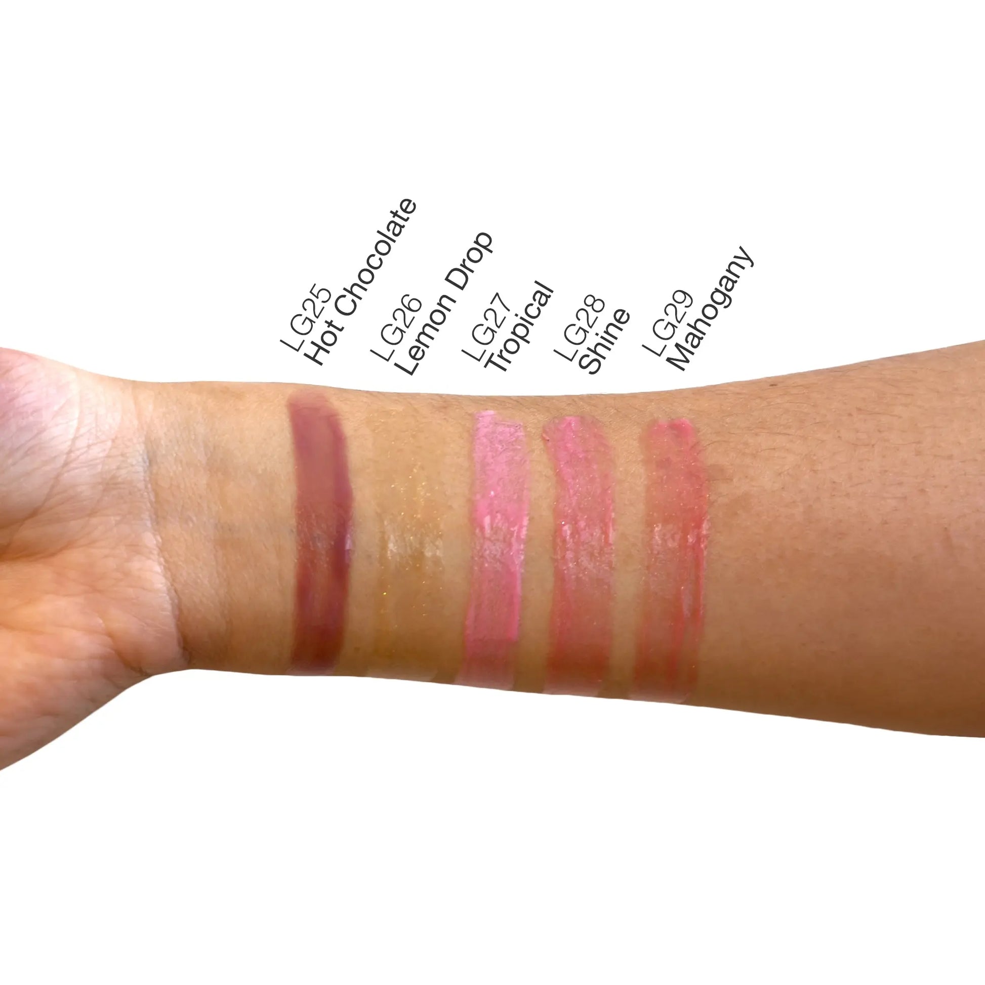 Pout Perfect lemon lip gloss swatch on arm along with other shades Hot Chocolate Tropical Shine and Mahogany