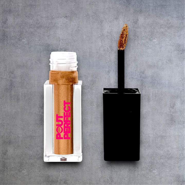 Pout Perfect liquid shimmer lip gloss in gold with applicator wand on gray background