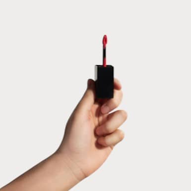 POUT PERFECT matte lip stain dusty pear in hand with applicator ready for use