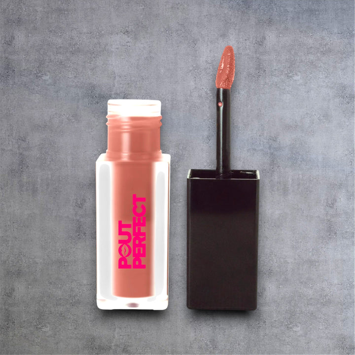 Pout Perfect matte lip stain dusty pear in clear bottle with black applicator wand on gray background