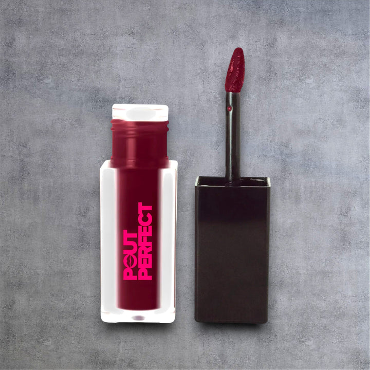 Pout Perfect matte lip stain long lasting in deep red shade with applicator wand on gray background